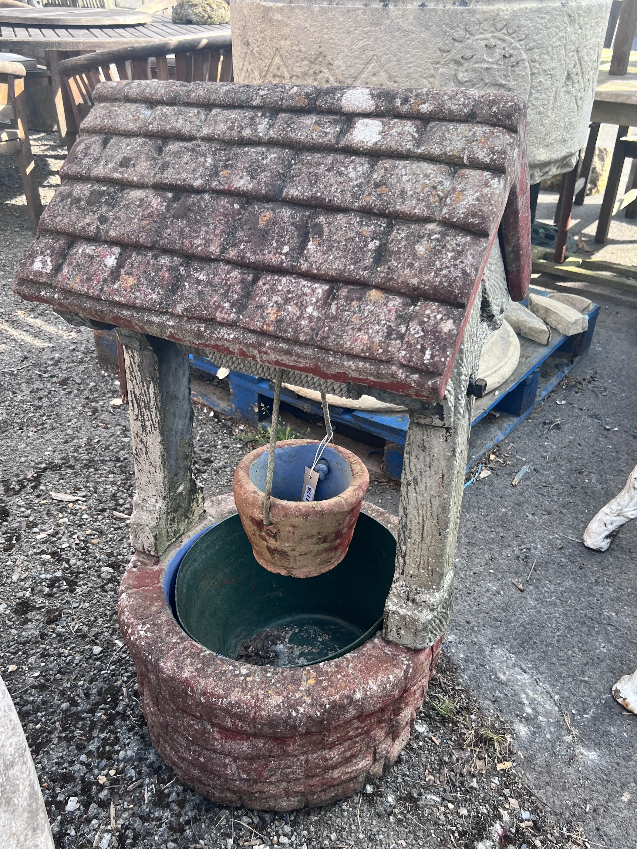 A large reconstituted stone ornamental wishing well garden planter, height 97cm